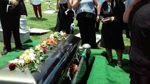 metal casket on artificial turf